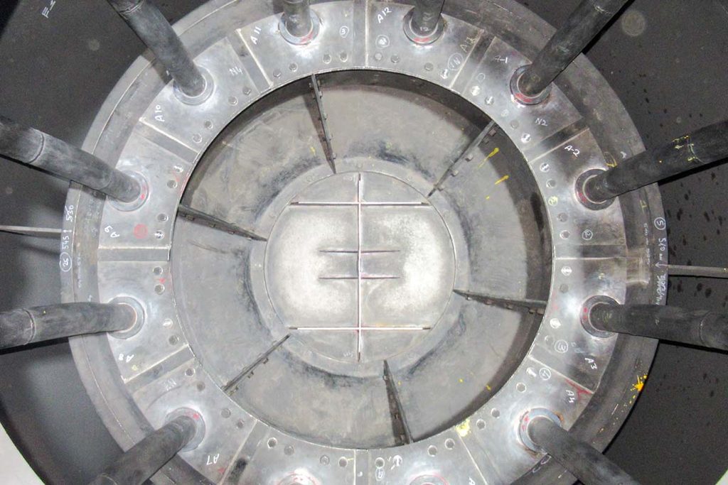 Top-down view inside a CCR reactor, showing the numbered segments and catalyst transfer pipes arranged around the centre.