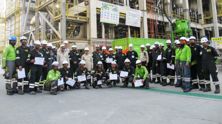 CR3 Middle East site team holding certificates in front of a refinery unit in the UAE after an emergency CCR reactor repair.